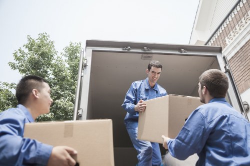 Man with a van loading furniture for a Stanmore home move