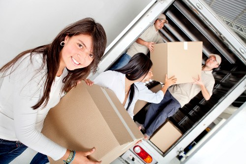 Removal workers carrying items from a Stanmore property with careful access planning