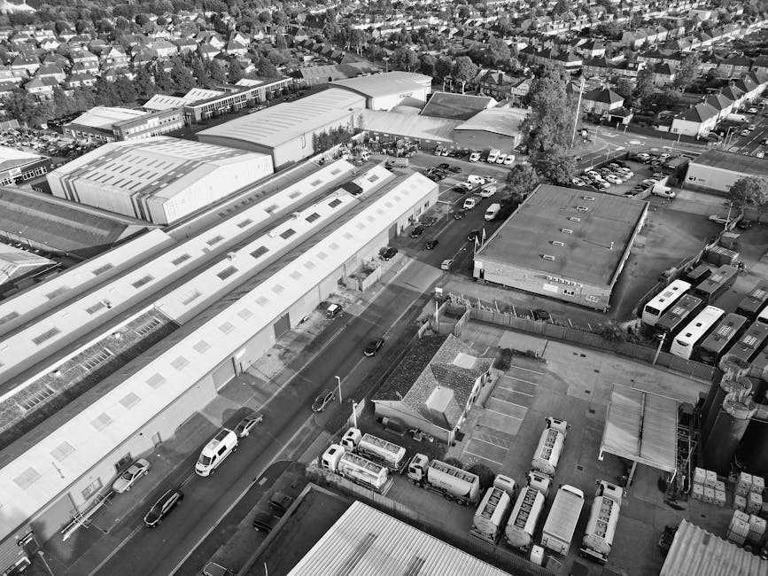 A black-and-white aerial photograph showing a residential neighbourhood with closely packed houses, including detached and semi-detached properties with pitched roofs, gardens, and driveways. The scen